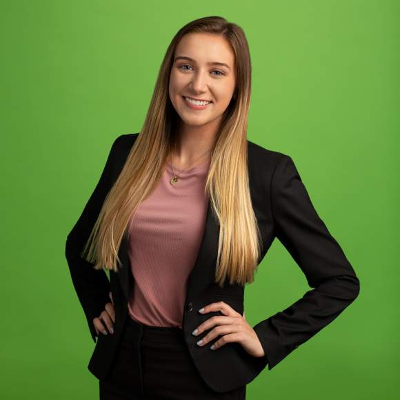 Erin George headshot on green background