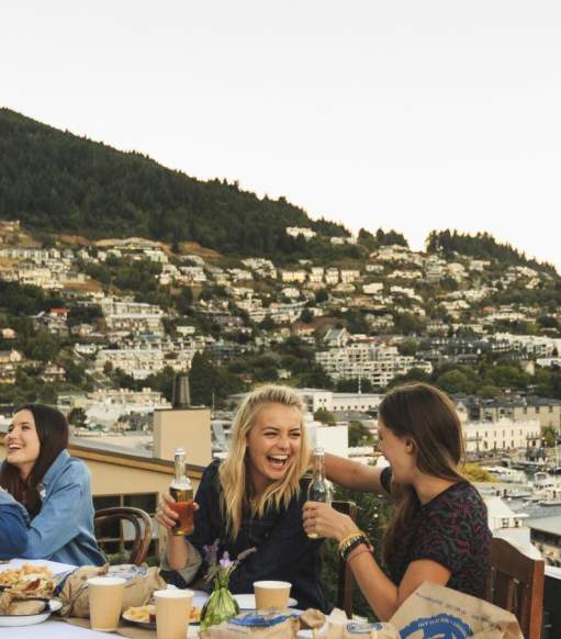 Backpackers dining on Queenstown Lakefront