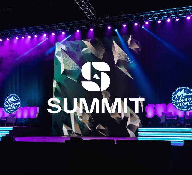 Stage setup with purple and blue lights, logos that say Silicon Slopes and a Summit Logo overlay