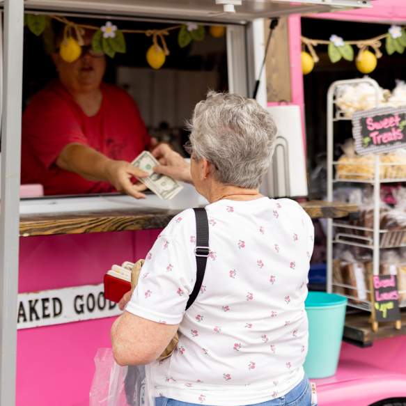 Pink food truck serving guests during a Denison community event