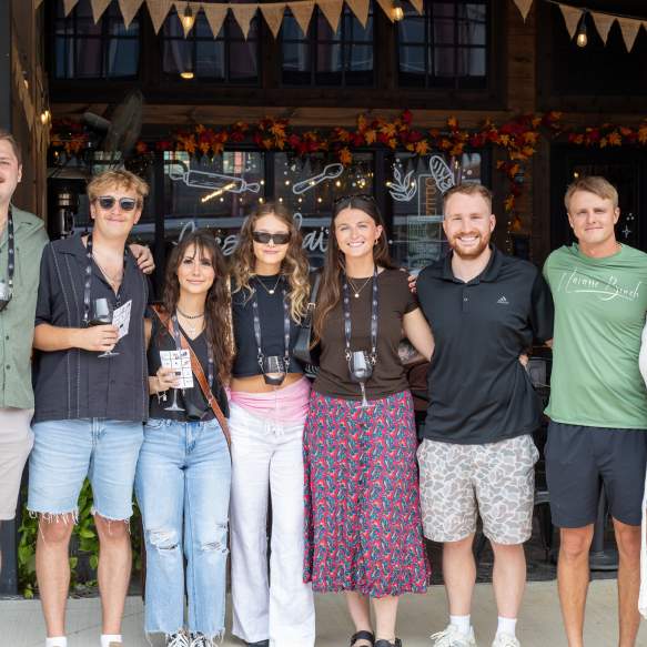 Friends posing together during a Downtown Denison Wine Walk event