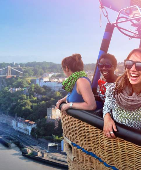 A group of people in a balloon basket flying near the Clifton Suspension Bridge in West Bristol - credit Paul Box