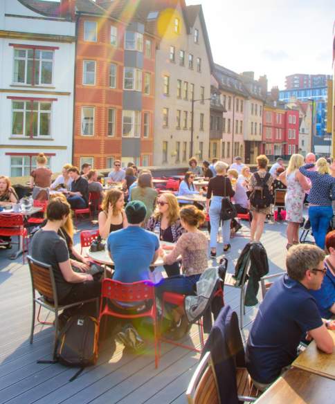 People sitting under the sun on the roof terrace at the Bambalan restaurant, central Bristol - credit Bambalan