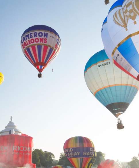A group of balloons lifting off in a mass ascent at Bristol International Balloon Fiesta - credit Paul Box