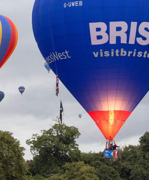 A group of balloons lifting off in a mass ascent at Bristol International Balloon Fiesta 2025