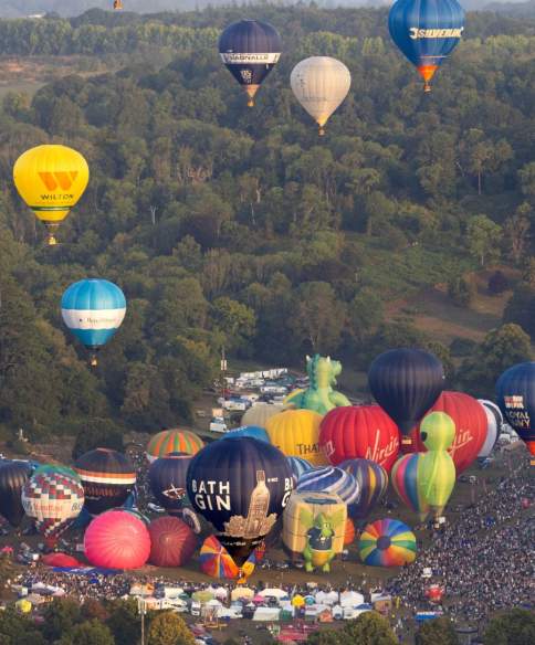 Balloons lifting off in a mass ascent at Bristol International Balloon Fiesta 2025
