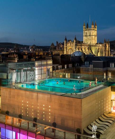 An aerial view of the rooftop pool at the Thermae Bath Spa at night