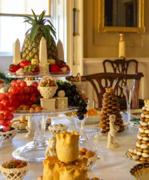 An image of several intricate Christmas foodstuffs arranged in an aesthetically pleasing manner on a table inside the No.1 Royal Crescent museum in Bath.