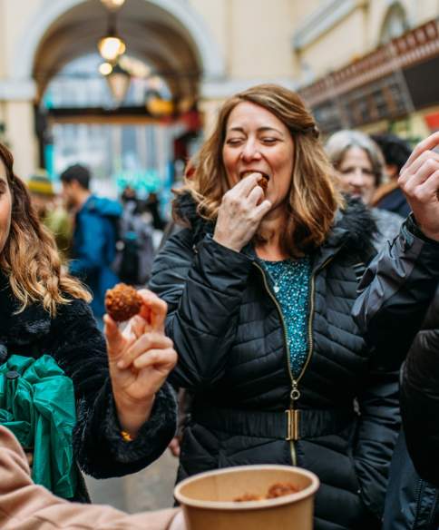 A group of people tasting food in St Nicholas Market on the Bristol Food Tour - credit Yuup