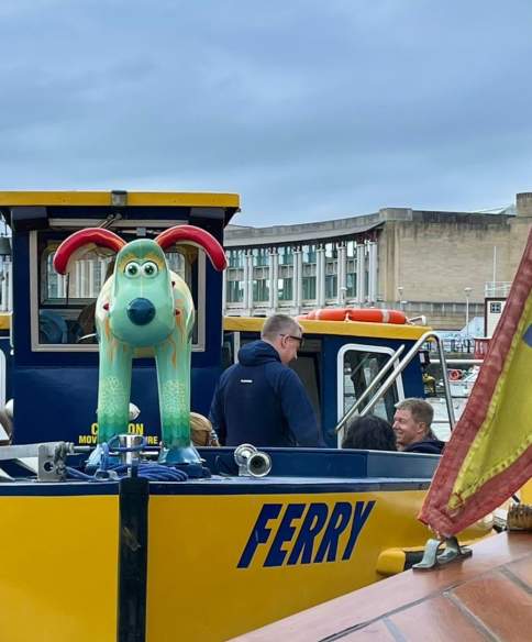 A yellow Bristol Ferry boat with a green gromit on the bow