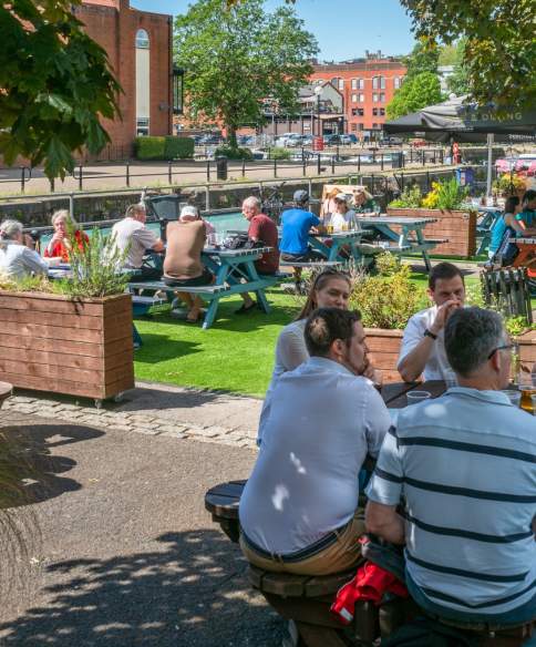 People sitting outdoors under the sun by The Ostrich pub in the Redcliffe area of Bristol - credit Mahtola Eagle