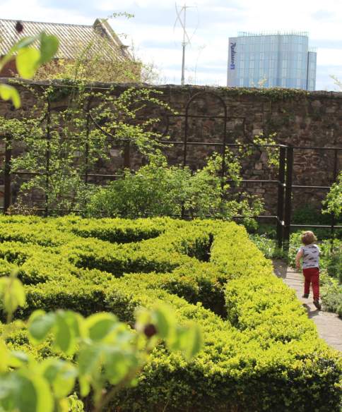 Child playing in the Tudor knot garden at The Red Lodge Museum in Bristol - credit Visit West