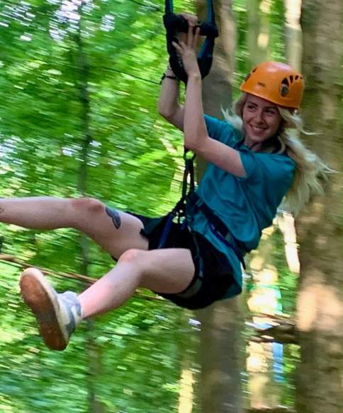 Person on zip line in tree tops - credit Adventure Bristol