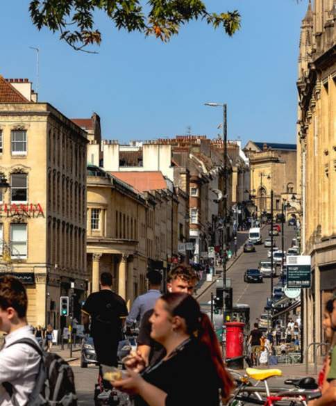 A view from the bottom of Park Street in central Bristol looking uphill with people in the foreground
