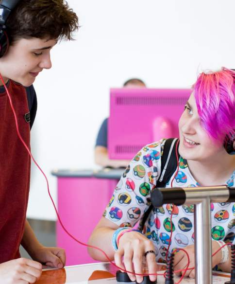 A boy wearing headphones trying one of the activities at the We The Curious science centre in Bristol - credit Paul Blakemore