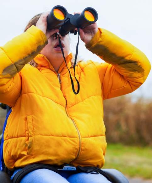 A wheelchair user birdwatching at WWT Slimbridge near Bristol - credit WWT Slimbridge