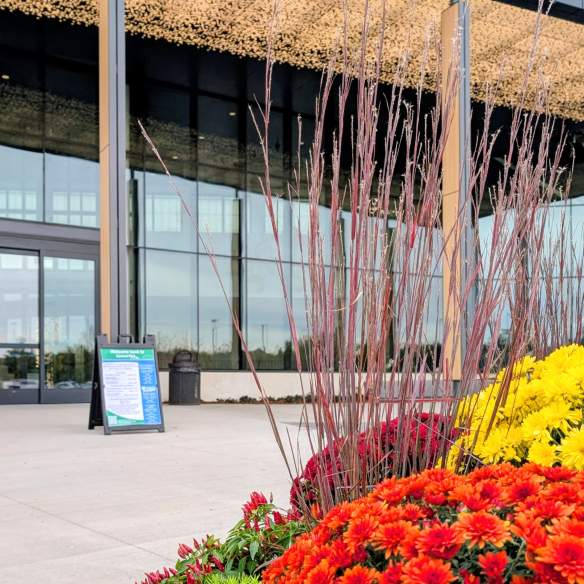 Central Park Woodbury main entrance decorated with flowers and exterior lights.