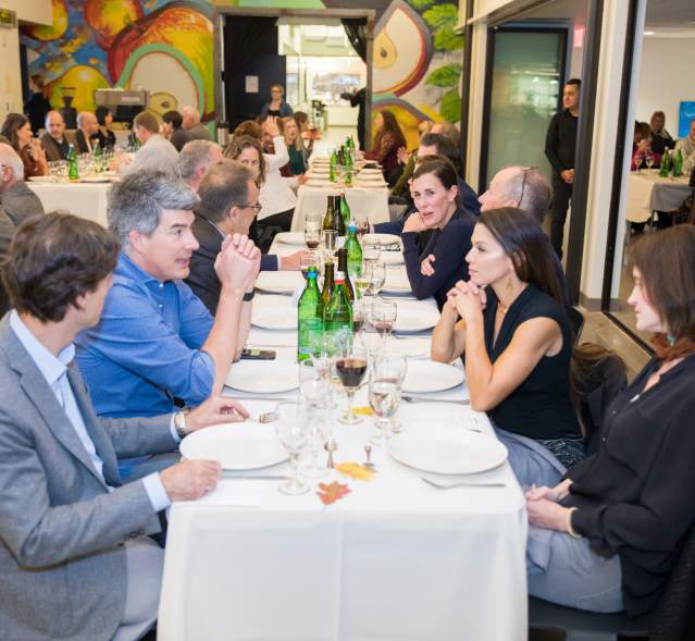 People sitting at tables inside Brightwater enjoying their meal