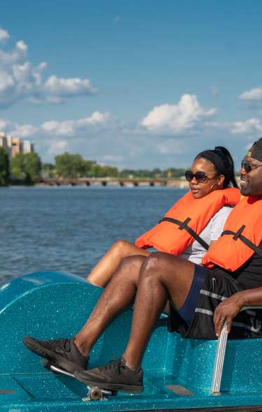 A couple paddle boating on Lake Monona bay