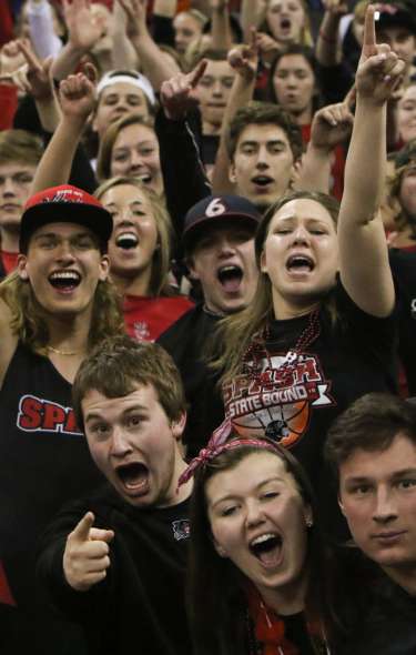 A group of students cheering in the stands at a WIAA State Tournament