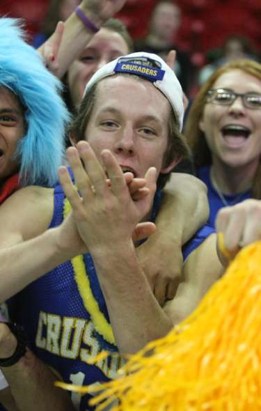 A group of WIAA fans cheering in the stands