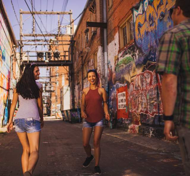 people walking through art alley in downtown rapid city, sd