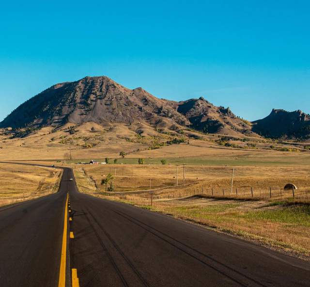 the road to bear butte state park with the mountain in the distance found in south dakota