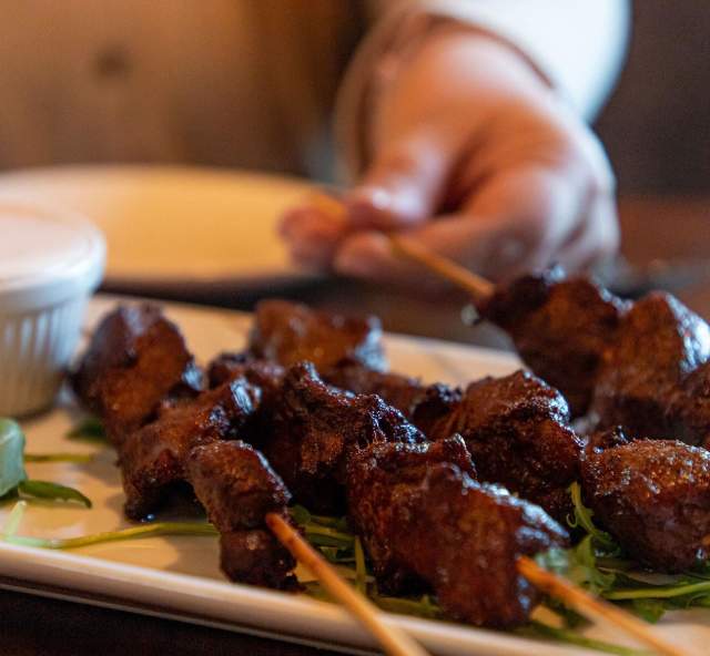 plate of chislic skewers with dipping sauce