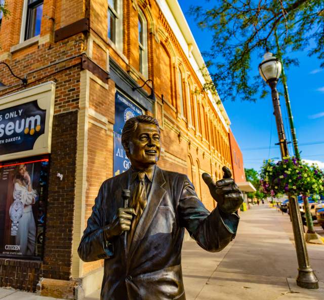 people walking past the james monroe statues, part of the city of presidents tour in rapid city, sd