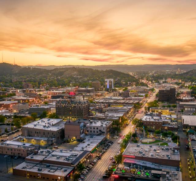 drone sunset view over rapid city with the black hills in view