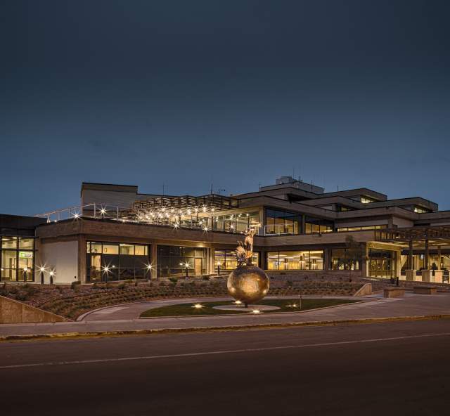 Exterior image of Rapid City Airport from parking lot at night.