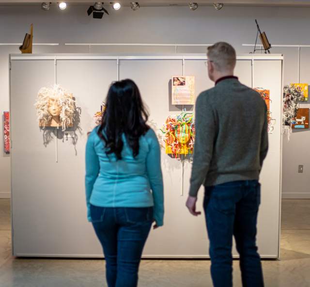 couple looking at the art on display in the suzie cappa art gallery