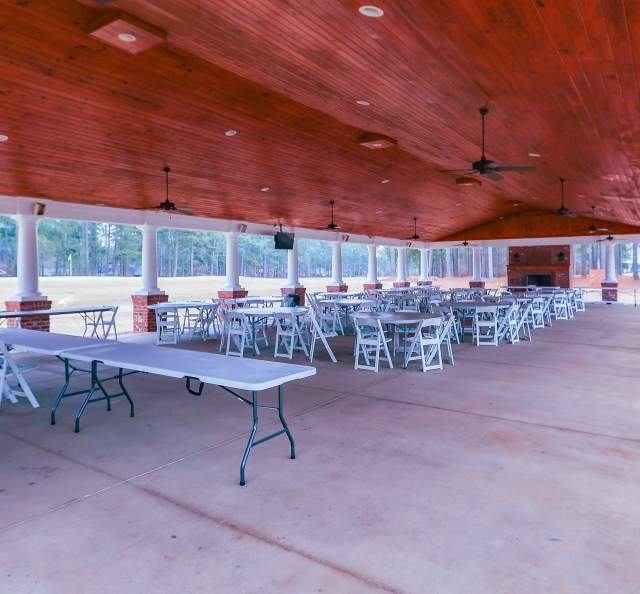 Large covered outdoor pavilion at Gates Four in Cumberland County featuring wooden ceiling, open-air views, and rows of tables and chairs for events or gatherings