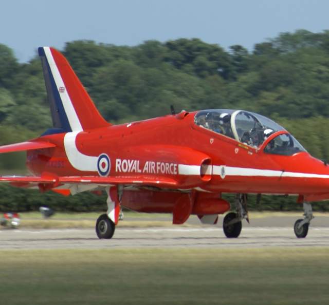 Red arrow plane on the run way getting ready for flight