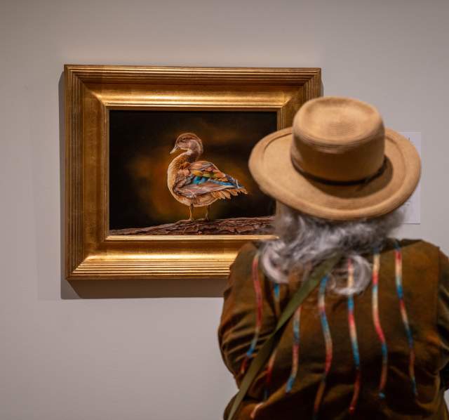 Woman looking at painting at Leigh Yawkey