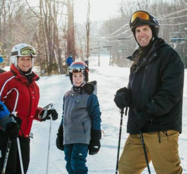 Family posing while skiing at Granite Peak