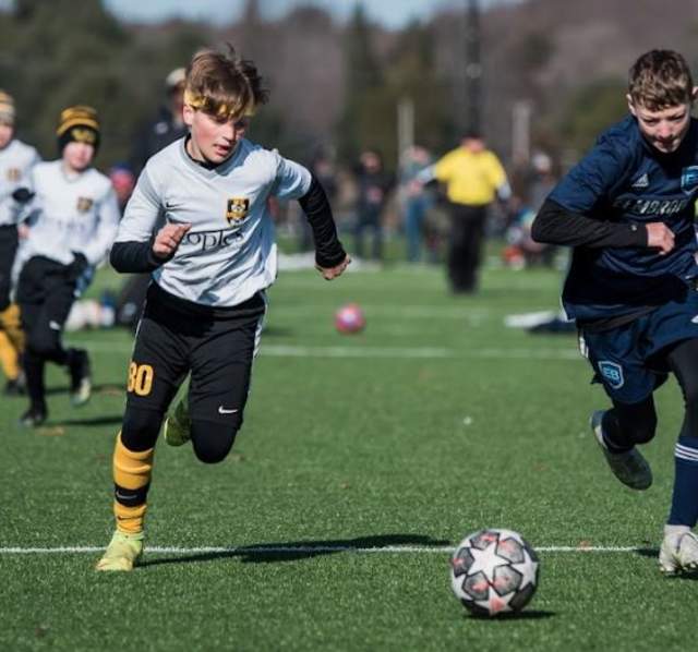Boys playing soccer at MC United tournament