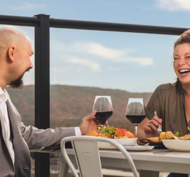 With Rib Mountain in the background, a couple dines at the rooftop restaurant, The Velveteen Plum
