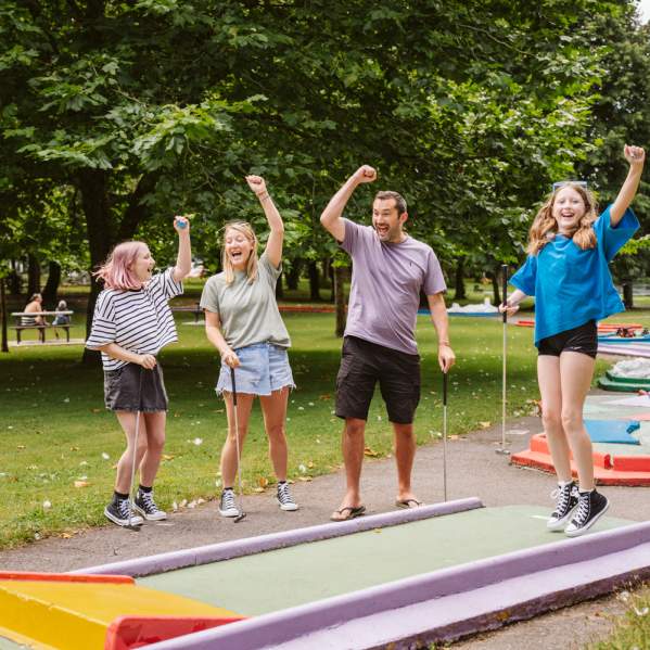 Family playing mini golf in Singleton Park
