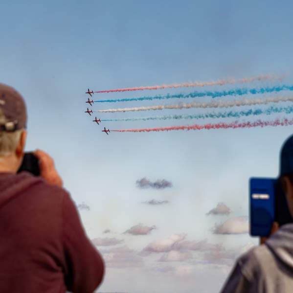 People taking photos of the red arrows at the Wales Airshow