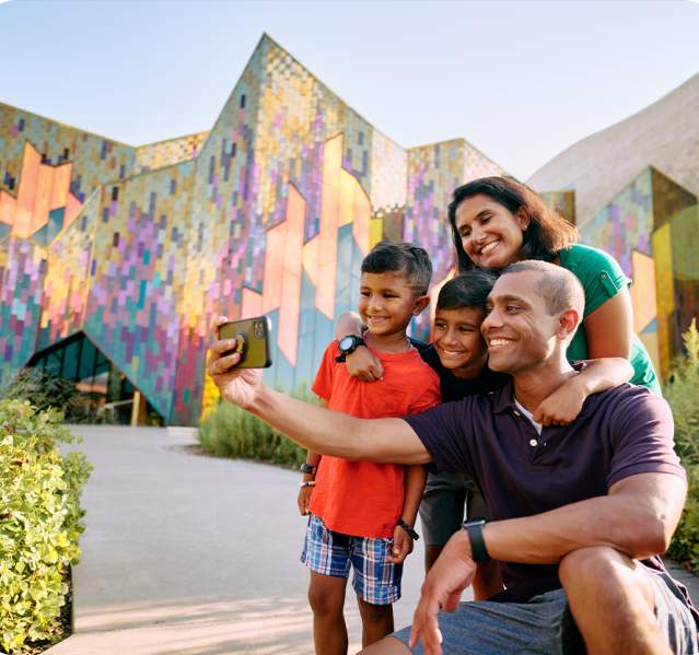A family poses for a photo during a visit to the Museum at Prairiefire in Overland Park