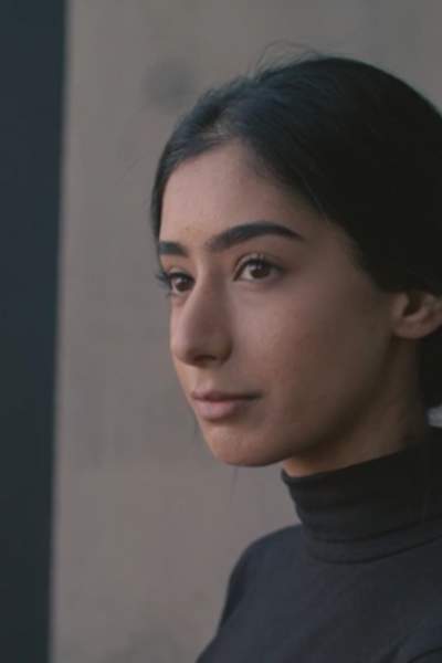 Firzah Ali, Citizen of Manchester, against a dark background