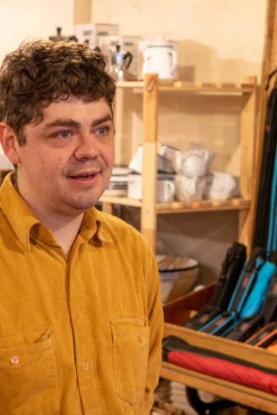 Liam, a shop owner and citizen of Manchester, inside his shop.