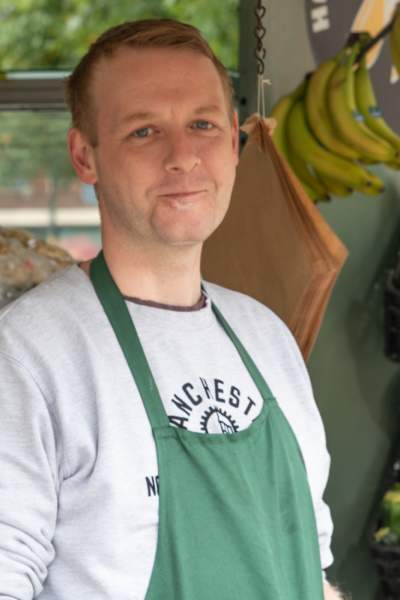 Nick, a fruit and vegetable seller from Manchester, outside his stall.