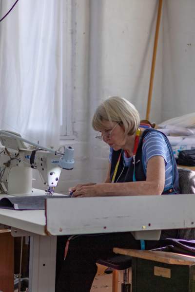 Sewing machinist Marian working on a garment