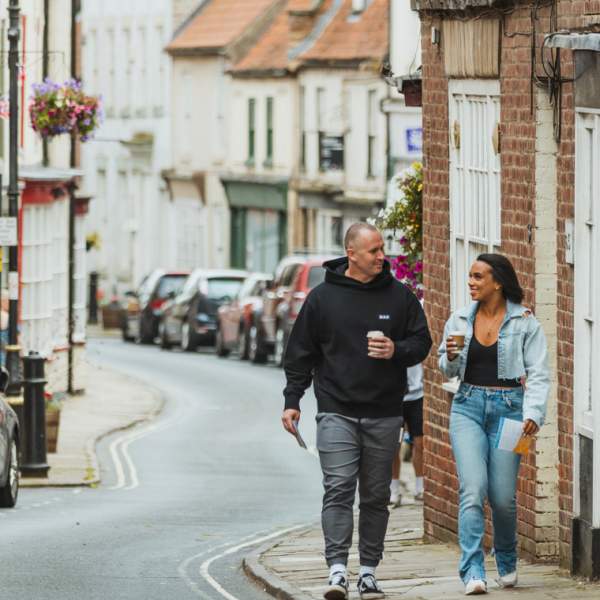 A couple walking through Bridlington's Georgian Old Town.