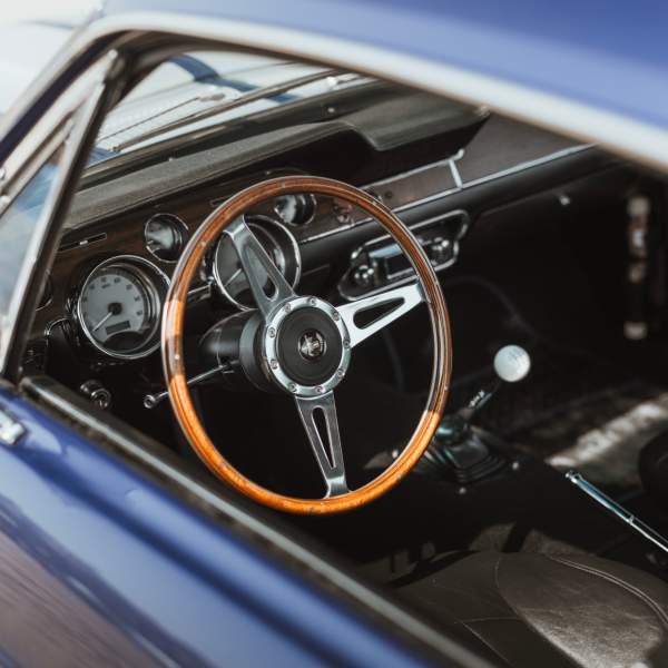 The interior of a car looking through the side window.