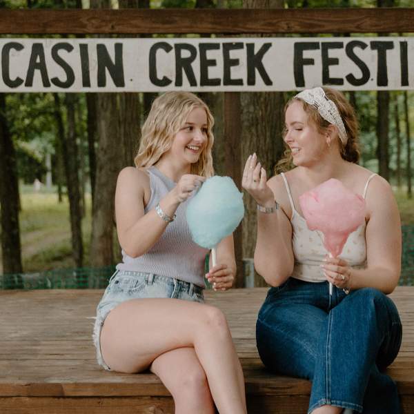 Friends enjoying cotton candy at one of the stages at Moccasin Creek Festival