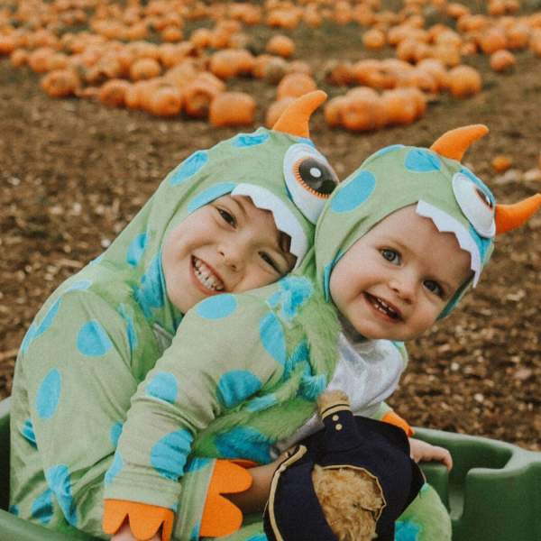 Children in fancy dress in pumpkin patch