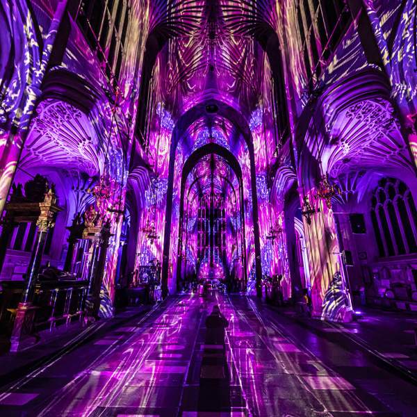 Luxmuralis light show of purple light and images on cathedral walls